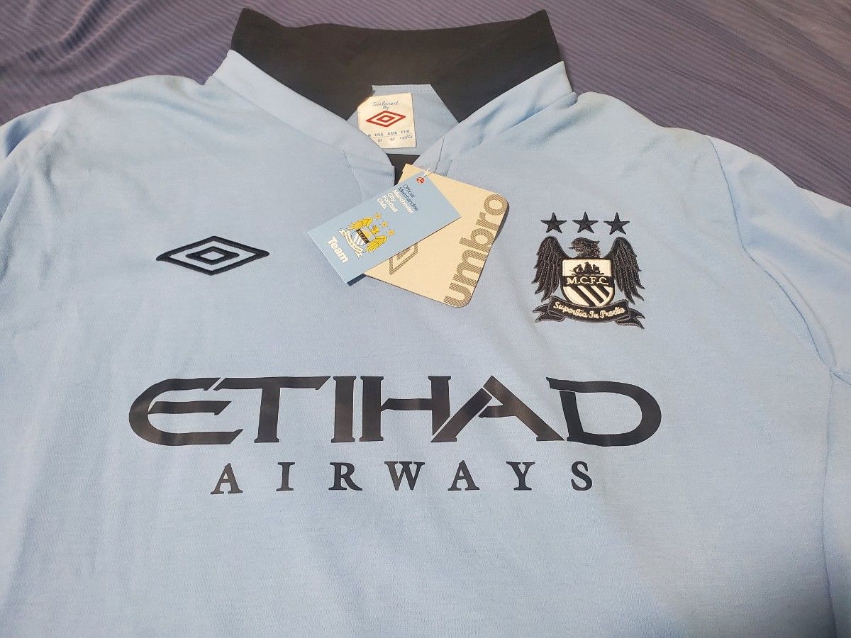 新品】【アンブロ正規品】マンチェスターシティ 襟付長袖 2012/13